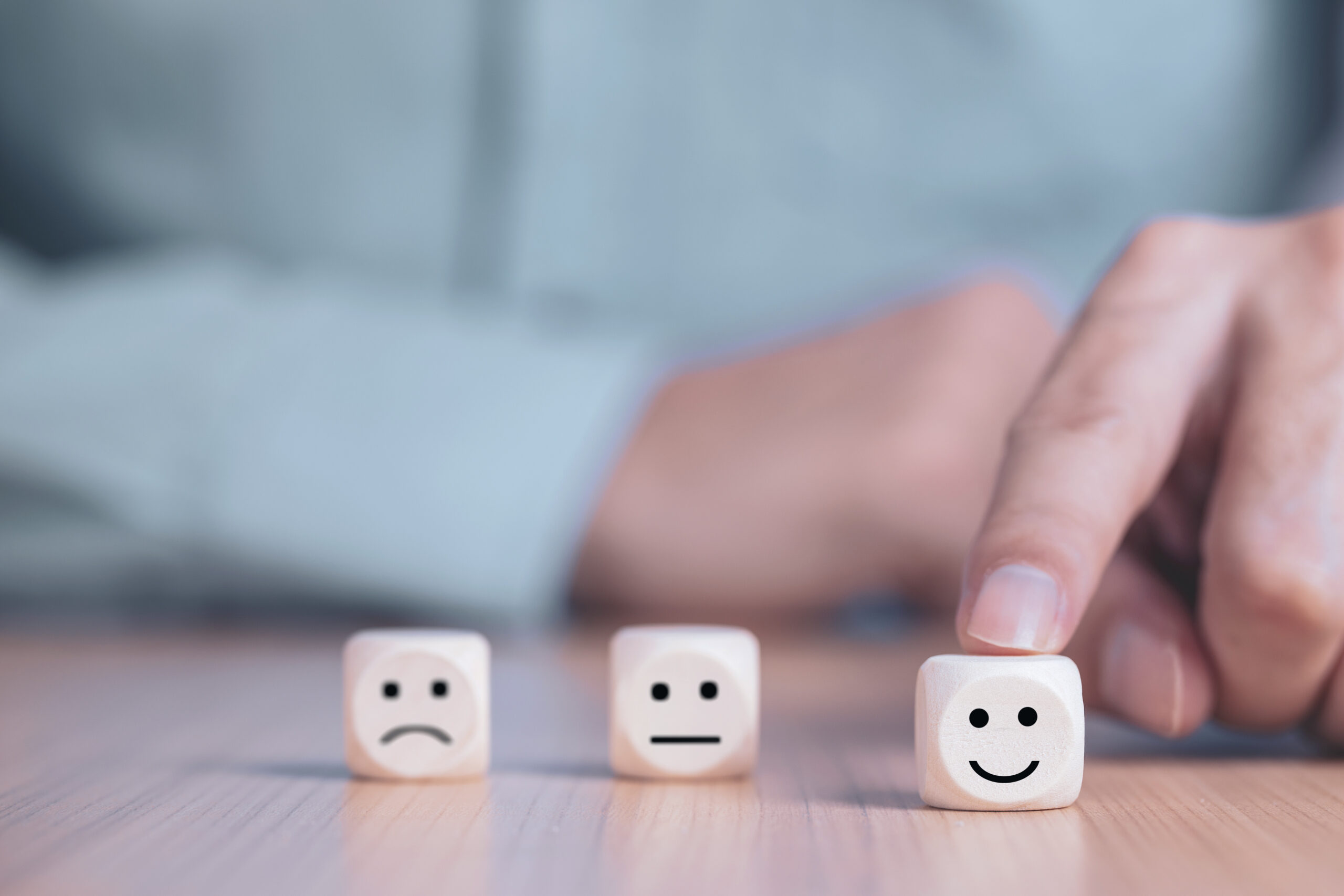 Businessman chooses a smile emoticon icons face happy symbol on
